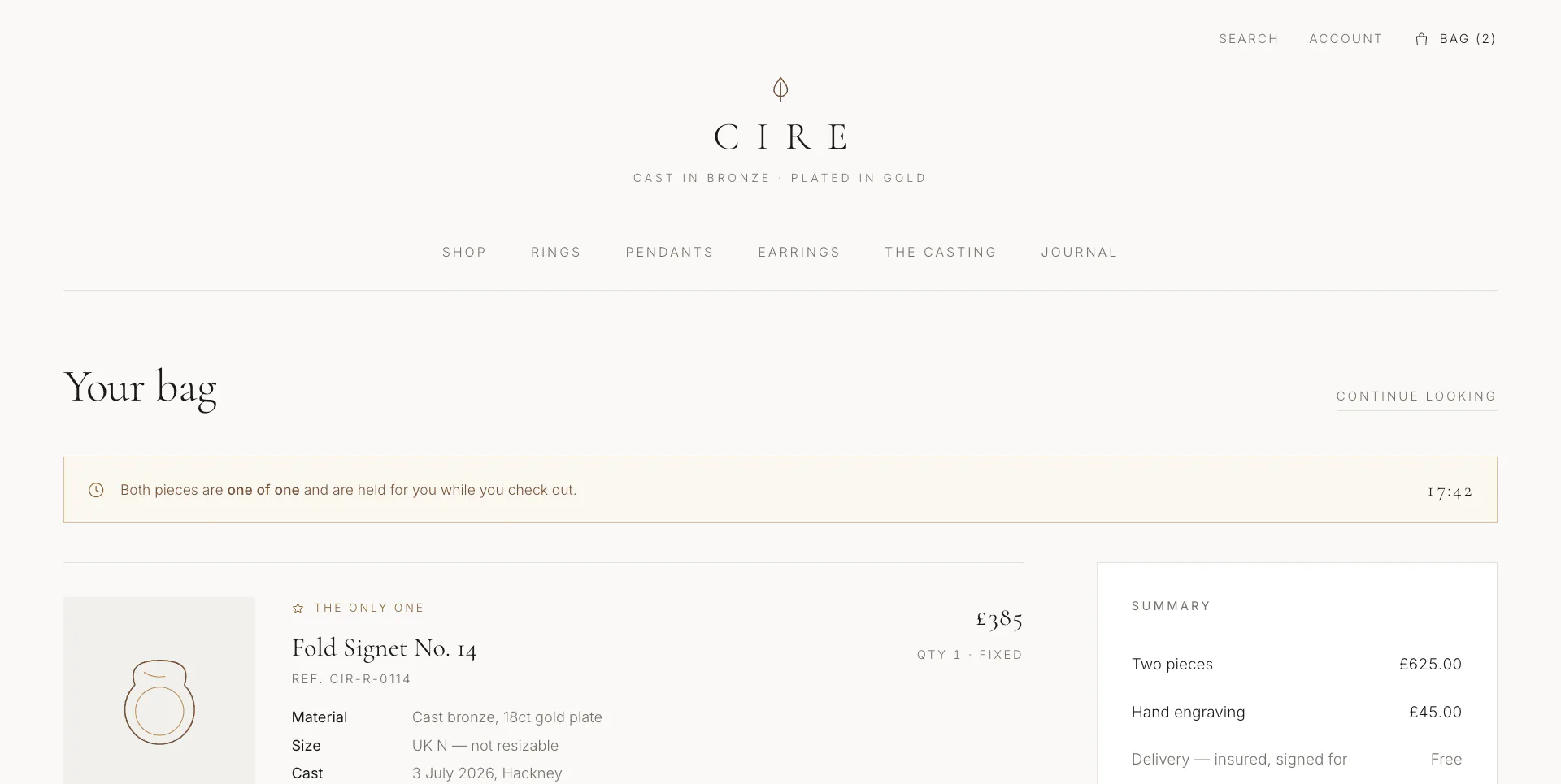 Shopping-bag page showing a single gold-plated signet piece with its materials and price